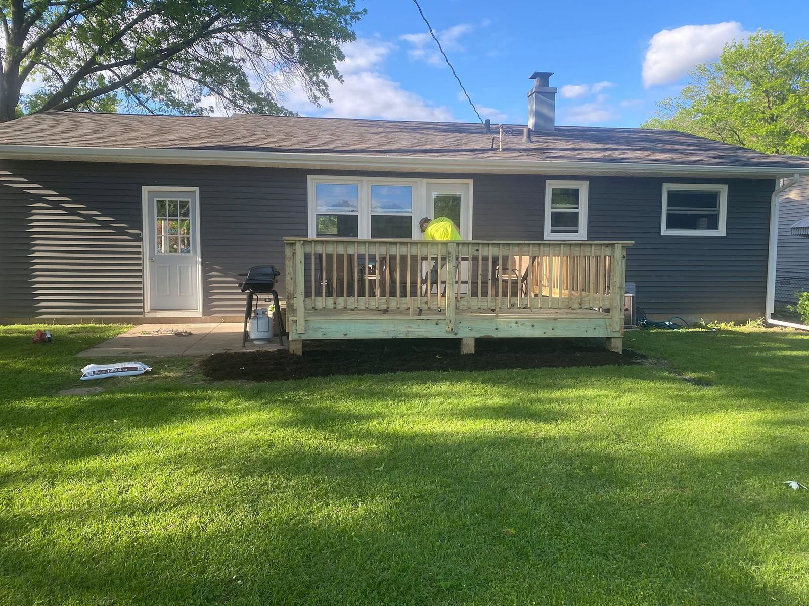 Backyard deck on a blue home in Davenport, Iowa