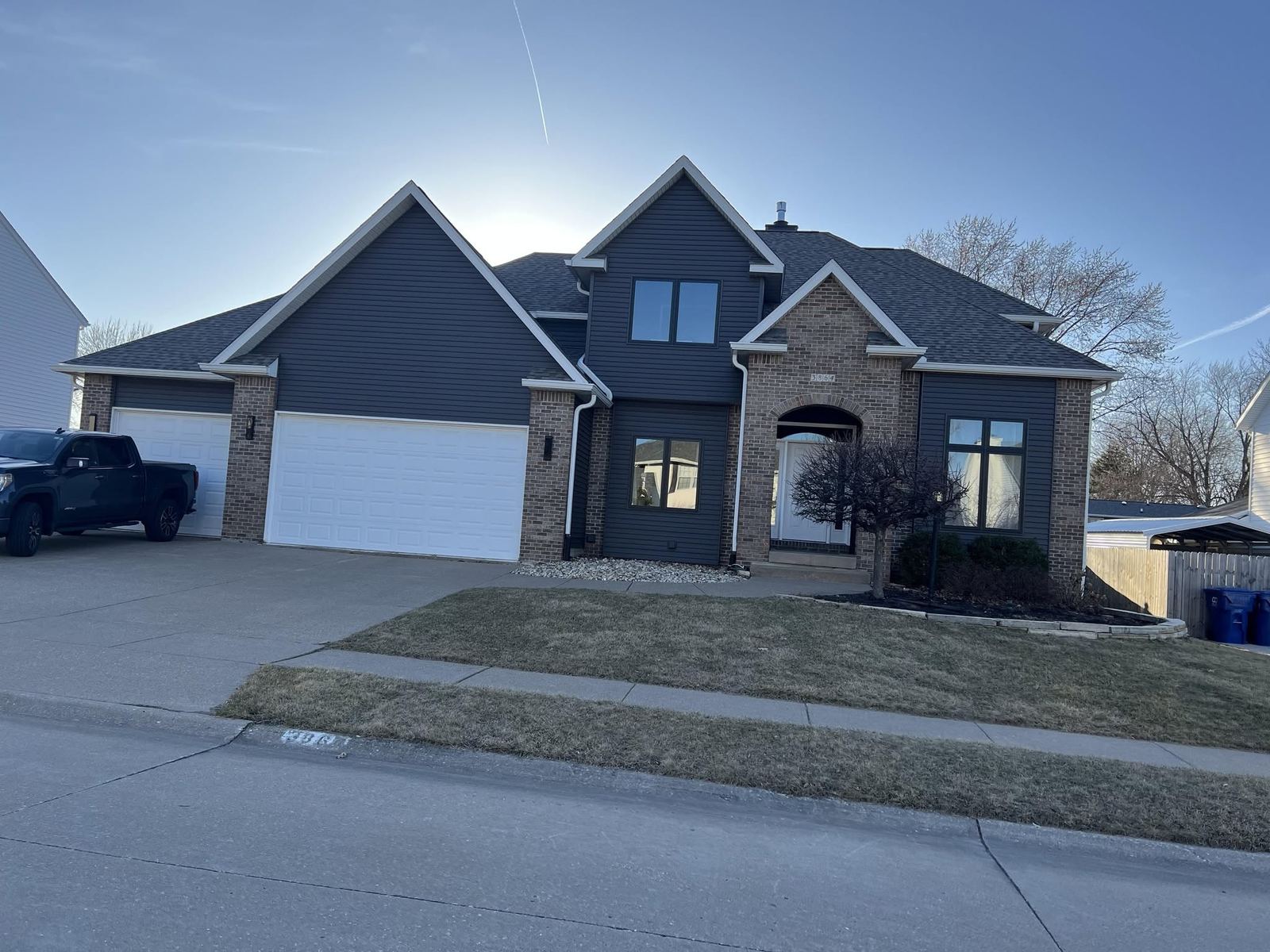 Blue two-story home with attached garage in Davenport, Iowa