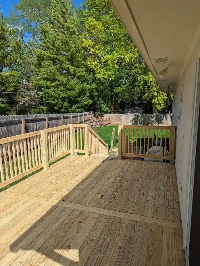 long wood deck with railing beside a home in Davenport, Iowa